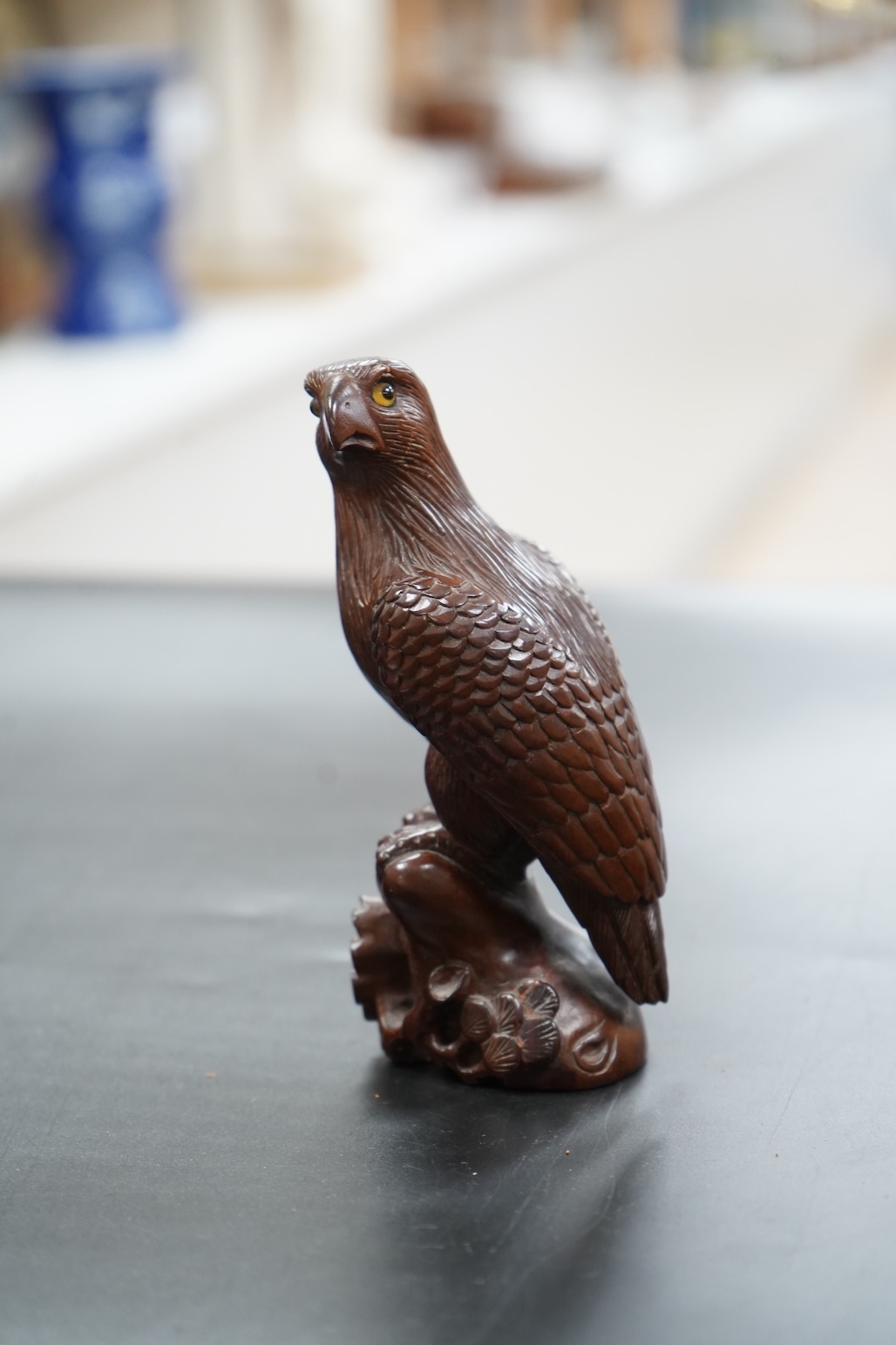 A Chinese rosewood carving of a hawk on base, with inlaid glass eyes, 13cm high